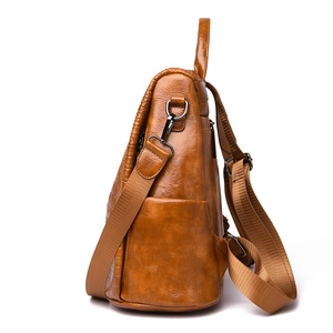 Side view of brown PU leather backpack with crocodile pattern and adjustable straps