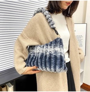 Detail of blue and white faux fur shoulder bag with pleated texture and plush strap