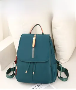 Detail of teal oxford fabric backpack with stylish red edged zipper and side pocket