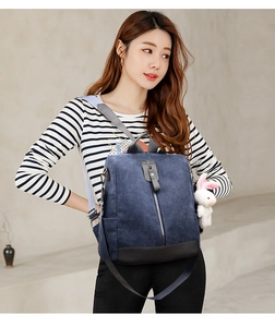 Blue corduroy backpack with leather details and a cute white rabbit pendant