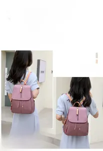 Detail view of purple nylon backpack featuring drawstring closure and flap design