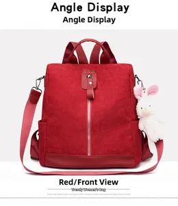 Front view of red corduroy multi-functional backpack with zipper and plush bunny charm