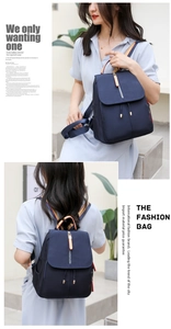 Detail of navy oxford backpack featuring water-resistant fabric and gold zipper accents
