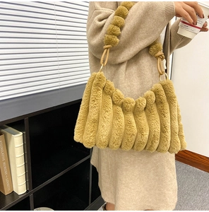 Detail of ginger plush tote bag with vertical stripes and knotted handle detail