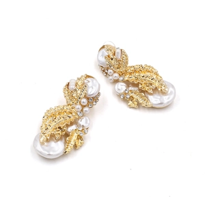Elegant gold leaf earrings with baroque pearls and sparkling crystals on white background