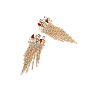 Detail of colorful crystal drop earrings with long gold tassel chains and rhinestones