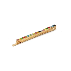 Golden hair clip with vibrant multi-color rhinestones in a minimalist rainbow design