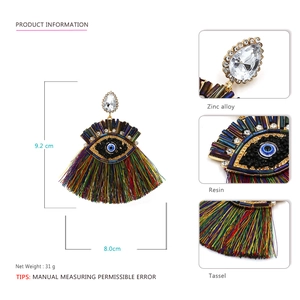 Colorful evil eye tassel earrings with resin teardrop stones and bohemian fringe details