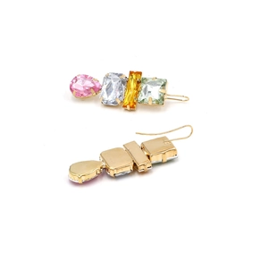 Detail of colorful geometric gemstone drop earrings with gold hooks and textured metal back