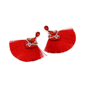 Close-up of red bohemian tassel earrings with sparkling rhinestones and beadwork detailing