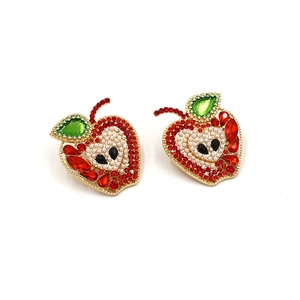 Close-up of apple earrings featuring red and green rhinestones with pearl details