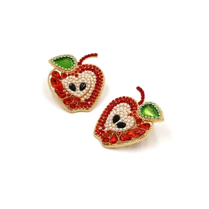 Apple stud earrings with red crystals, pearls and gold finish on white background