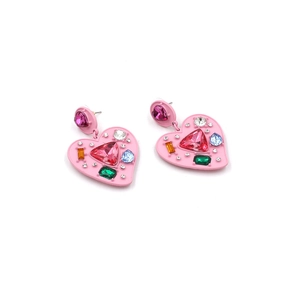 Macro detail of heart-shaped earrings with colorful crystals and pink enamel finish