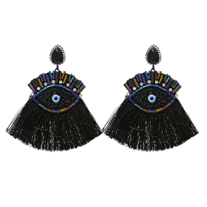 Handmade black beaded evil eye tassel earrings featuring vibrant blue central eye detail