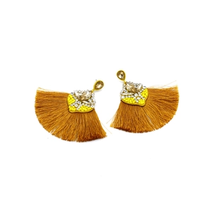 Detail of yellow heart bohemian tassel earrings with champagne crystal and rhinestone stud