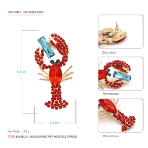 Fashionable gold lobster drop earrings with red rhinestones and blue crystals
