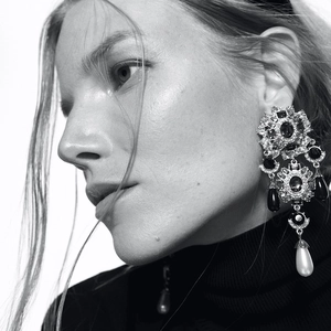 Baroque floral drop earrings with pearls and crystals shown on a model side profile