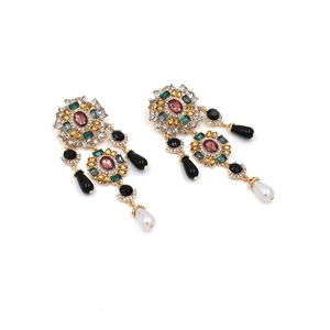 Long vintage metal flower earrings with pearls and colorful zircons on white background
