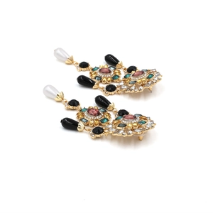 Detailed macro shot of vintage gold flower earrings with colorful gems and pearls