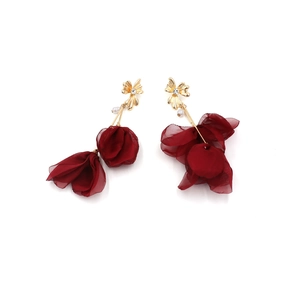 Detail of red fabric flower earrings with gold studs, small crystal and white pearls