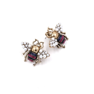 Vintage gold bee stud earrings with pearl wings and crystal abdomen on white background
