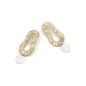 Macro detail of gold wire wrap earrings featuring sparkling rhinestones and shell pendants