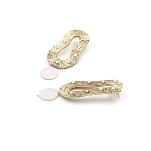 Detailed view of handmade gold wire wrapped waterdrop earrings with white pearl accents