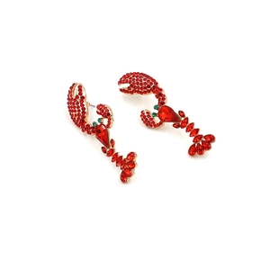 Detailed view of creative lobster earrings with red rhinestones and green crystal eyes