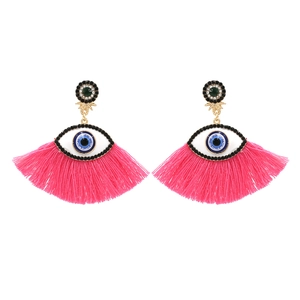 Bohemian evil eye earrings with pink silk tassels and crystal accents on white background