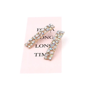 Minimalist geometric gold earrings with AB colorful rhinestones on a pink display card