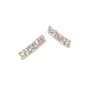 Detailed macro view of geometric earrings with colorful AB rhinestones on gold base