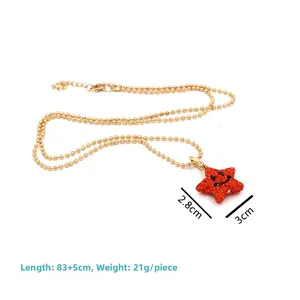 Detail of 83cm gold bead necklace with red rhinestone star pendant showing dimensions