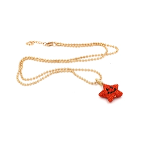Golden ball chain necklace featuring a red pavé star pendant with a smiling face design