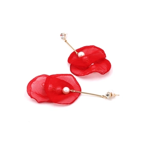 Detail of red lace flower earrings with gold bar, white pearl, and rhinestone accents