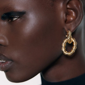 Creative gold twisted double hoop geometric earrings featuring textured metallic finish