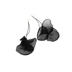 Close-up of black lace flower drop earrings with sheer tulle petals and gold hooks