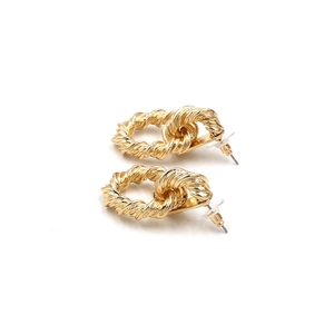 Detail view of gold twisted rope hoop earrings with double-layered textured design