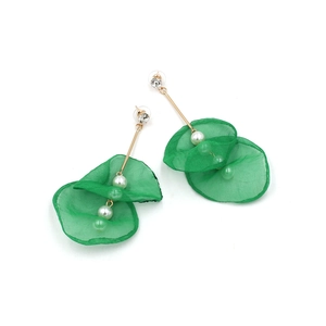 Detail of long floral pearl tassel earrings with green lace petals and golden rods