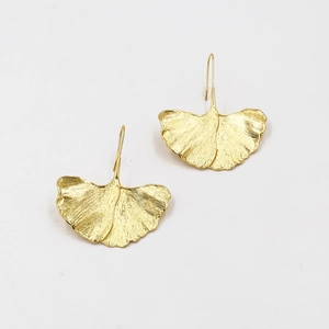 Detailed view of golden ginkgo leaf earrings showing intricate leaf vein textures