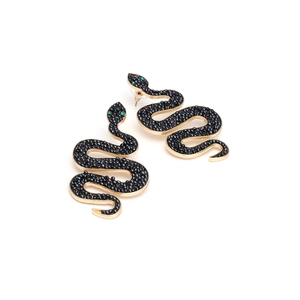 Close-up of gold snake earrings with black seed beads and tiny green gemstone eyes