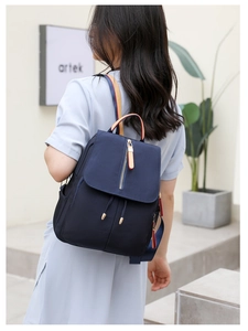Navy blue oxford fabric women backpack with leather trim and gold zipper detail