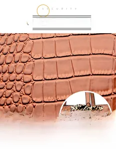 Detail of brown crocodile embossed leather bag with leopard print scarf and gold logo