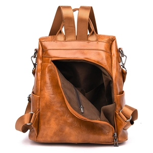Macro shot of anti-theft rear zipper and interior lining of the brown leather backpack