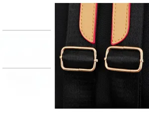 Detail of adjustable black fabric shoulder strap with gold buckle and leather trim on bag