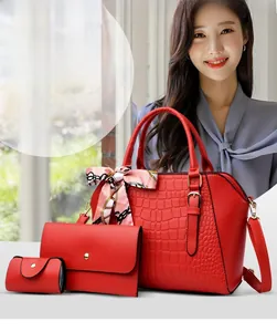 Detailed view of red embossed tote bag set with floral scarf and matching pouches
