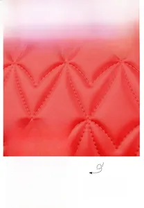Detail of red quilted waterproof fabric and premium gold metal zipper on shoulder bag