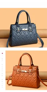 Detail of quilted leather bags in blue and orange-brown with golden rotating metal locks