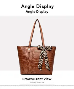 Close-up of brown crocodile pattern tote bag featuring a leopard print bow and metal logo