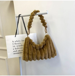 Detail of caramel plush shoulder bag showing soft pleated texture and fluffy handle