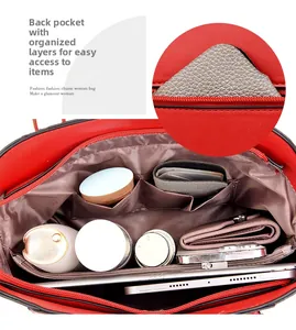Internal view of red handbag featuring multiple layers, zipper pocket and large capacity